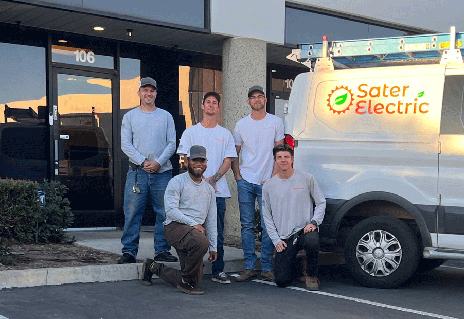 sater electric - a solar energy company photo of 5 staff in company tee shirts next to sater electric branded van in front, taken in warehouse parking lot